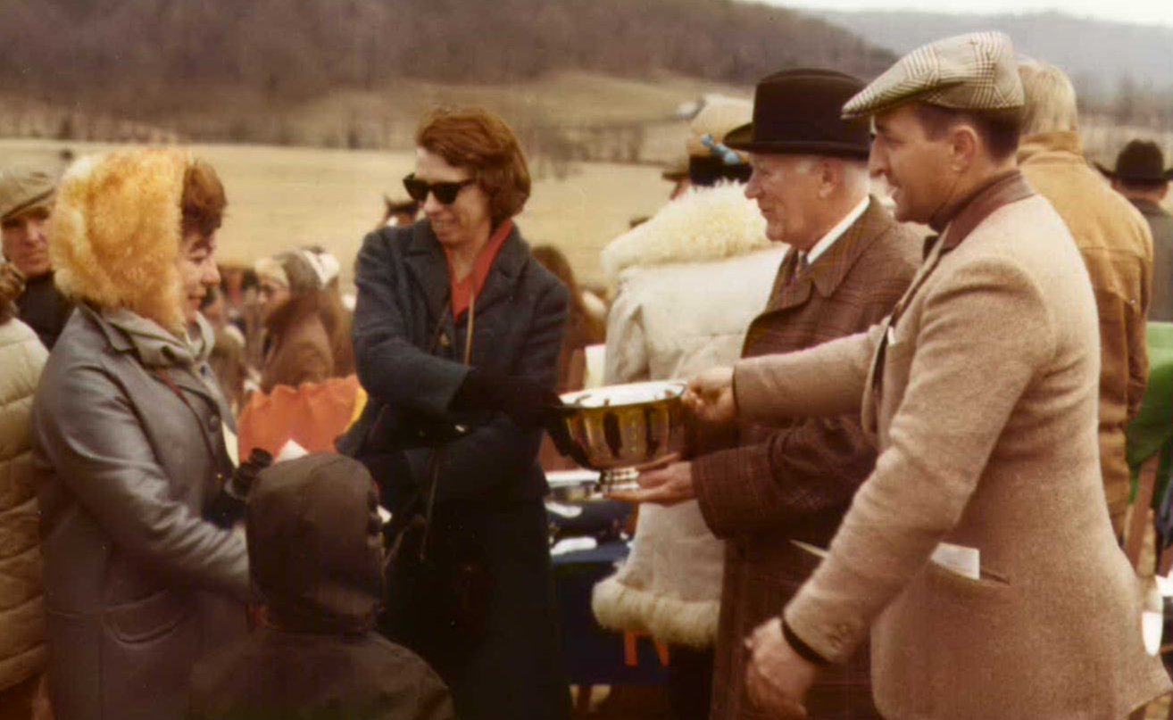Mignon C. Smith being presented with a trophy at a hunt event