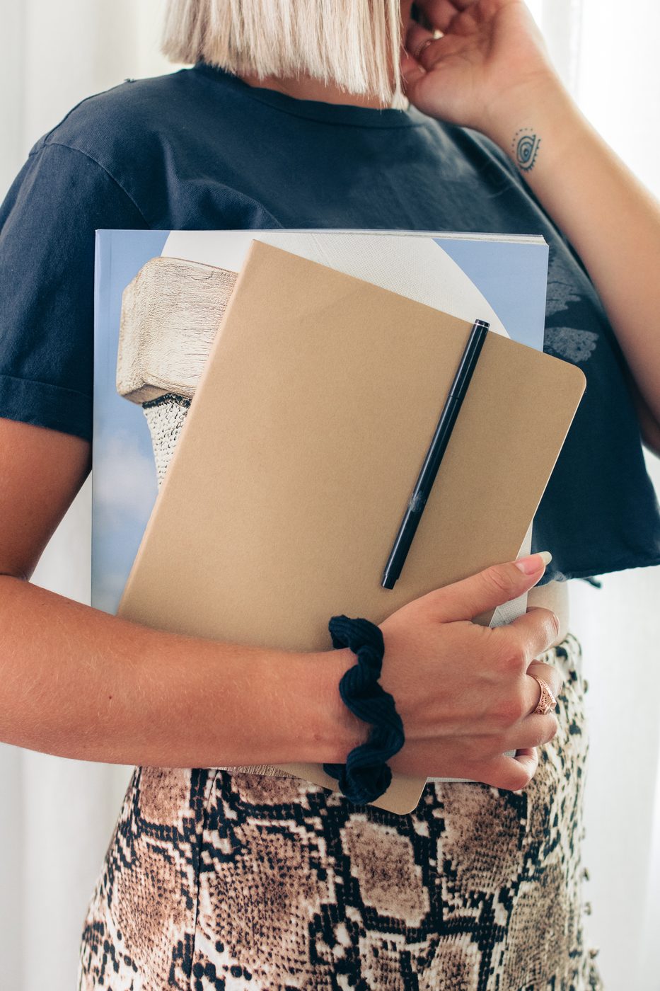 Student holding books and a notebook
